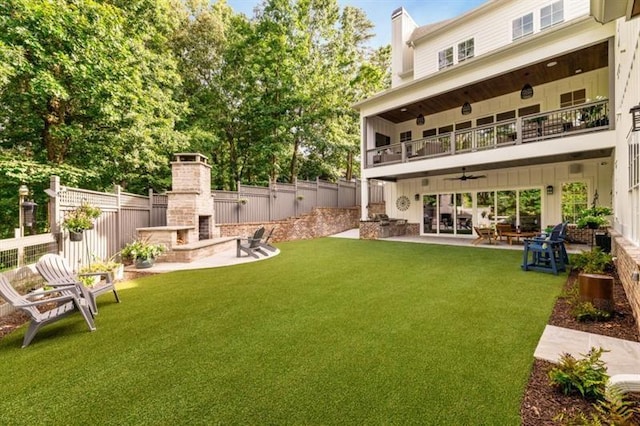 back of house with a patio area, a fenced backyard, a balcony, and an outdoor brick fireplace