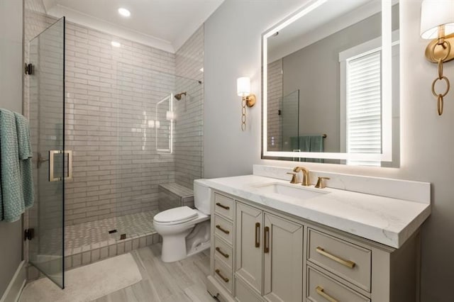 bathroom with wood finished floors, vanity, a shower stall, and toilet