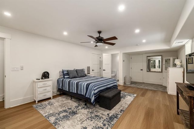 bedroom with ensuite bath, baseboards, recessed lighting, and light wood-style flooring