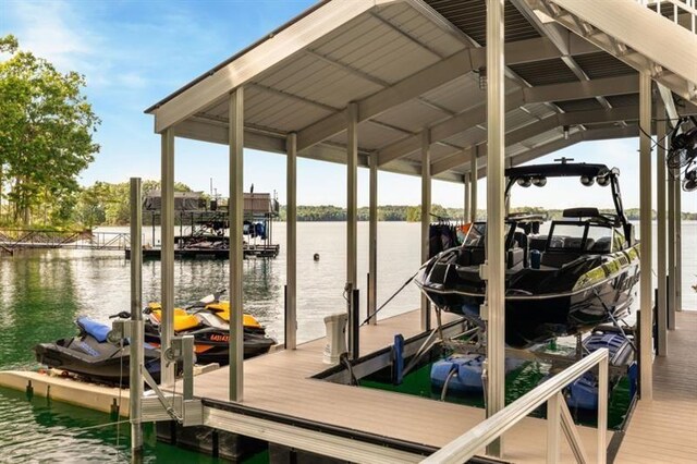 dock area featuring boat lift and a water view