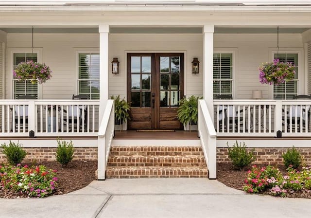 entrance to property featuring french doors and covered porch