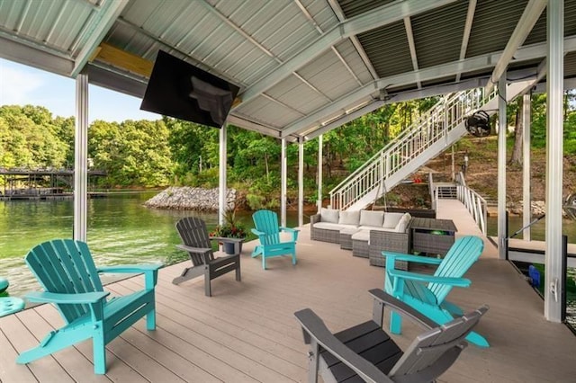 dock area with an outdoor hangout area, a deck with water view, and stairs