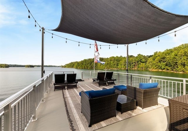 view of dock with a deck with water view and outdoor lounge area