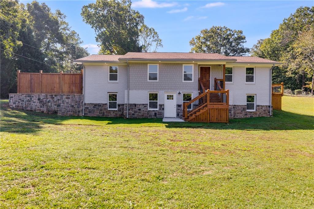 rear view of house with a yard