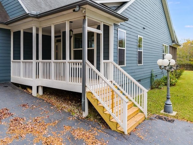 view of side of property featuring a sunroom