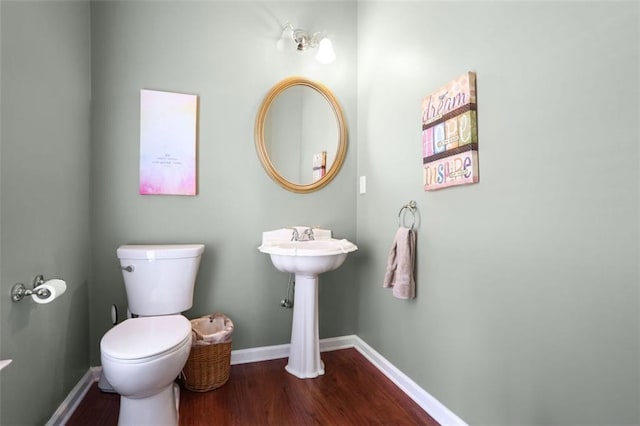 bathroom featuring hardwood / wood-style flooring and toilet