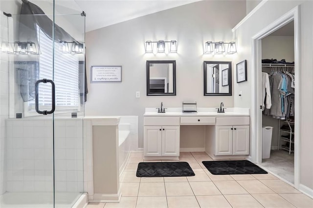 bathroom featuring tile patterned flooring, vanity, independent shower and bath, and lofted ceiling