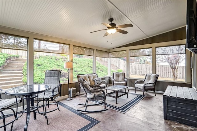 sunroom / solarium with ceiling fan and lofted ceiling