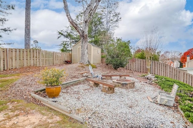 view of yard with a storage shed and an outdoor fire pit