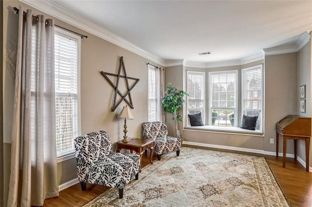 sitting room featuring wood-type flooring and crown molding