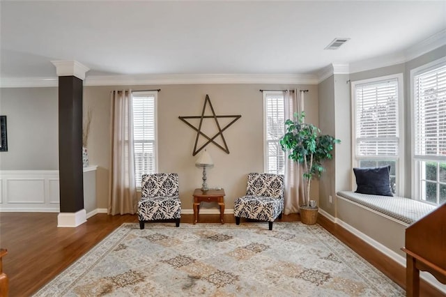 sitting room featuring wood-type flooring and crown molding