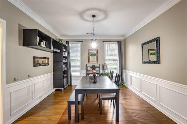 dining room featuring dark hardwood / wood-style flooring and crown molding