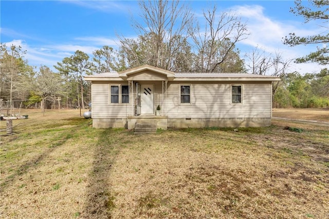 view of front of house with a front yard, crawl space, and metal roof