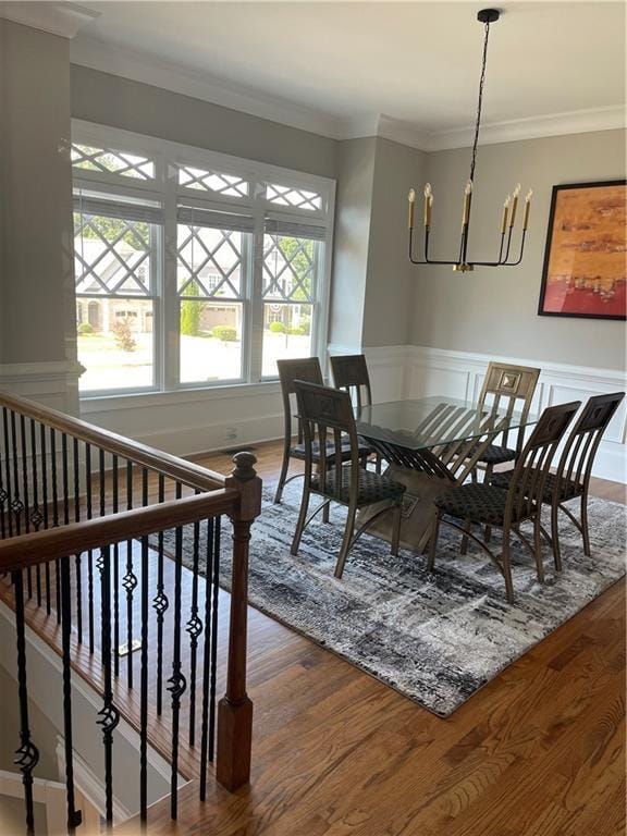103 Mill Park Chase, Woodstock, GA 30188 - dining space featuring a chandelier, wood finished floors, crown molding, and a wainscoted wall