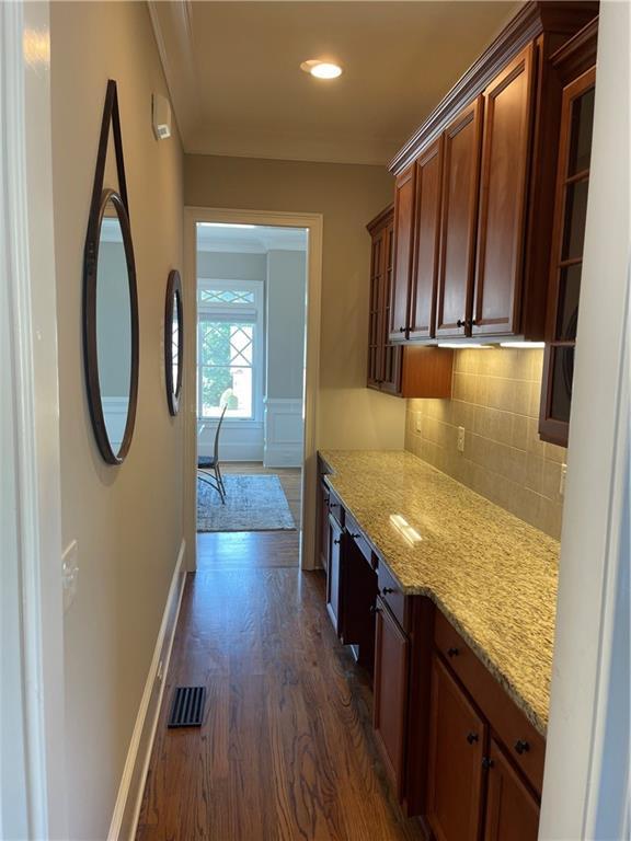 103 Mill Park Chase, Woodstock, GA 30188 - kitchen featuring dark wood-style floors, backsplash, light stone counters, recessed lighting, and brown cabinets