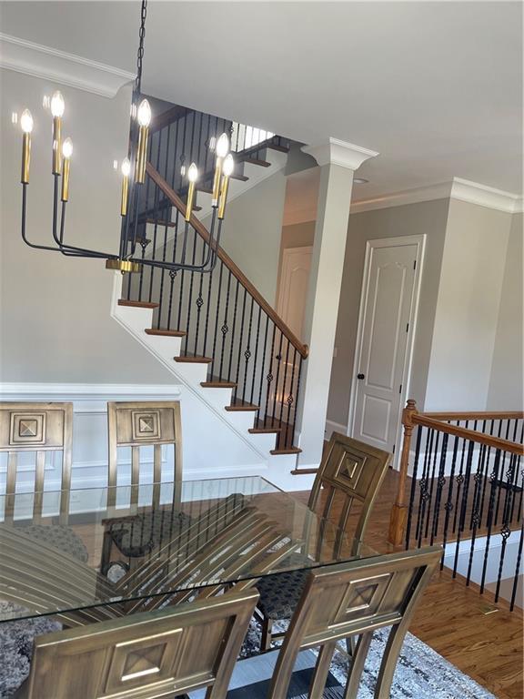 103 Mill Park Chase, Woodstock, GA 30188 - stairway with ornamental molding, wood finished floors, and a chandelier