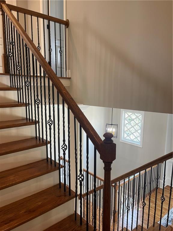 103 Mill Park Chase, Woodstock, GA 30188 - stairs with wood finished floors and a chandelier