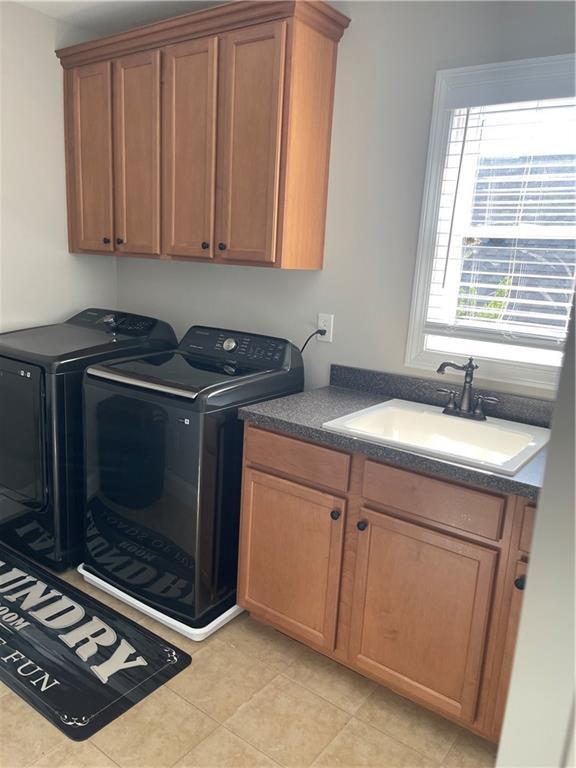 103 Mill Park Chase, Woodstock, GA 30188 - laundry room with independent washer and dryer, cabinet space, and light tile patterned flooring