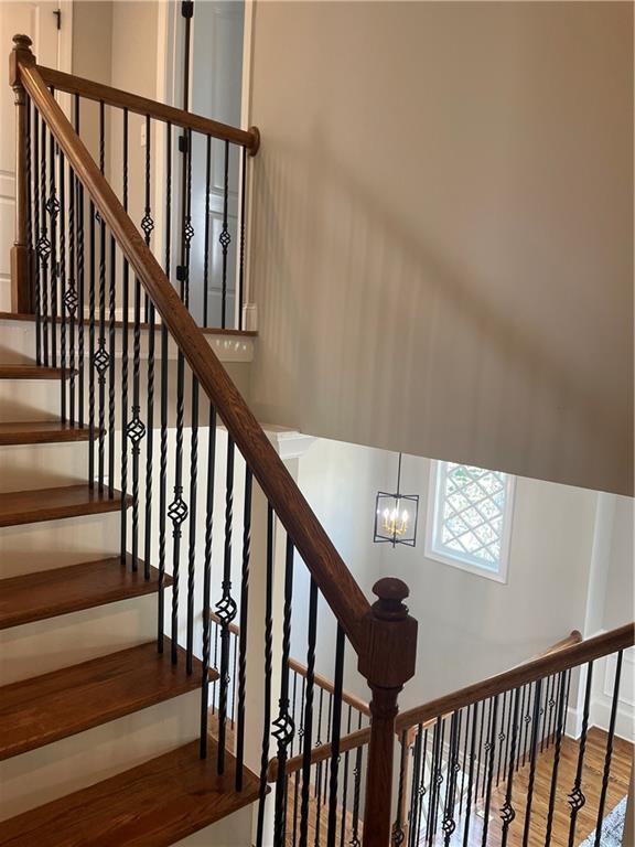 103 Mill Park Chase, Woodstock, GA 30188 - staircase featuring wood finished floors and a chandelier