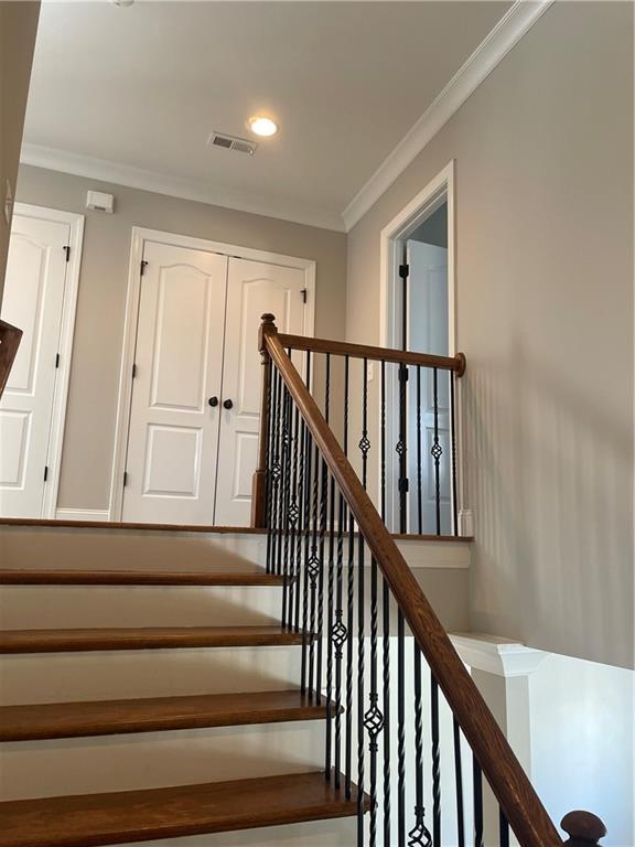 103 Mill Park Chase, Woodstock, GA 30188 - stairs featuring crown molding and recessed lighting