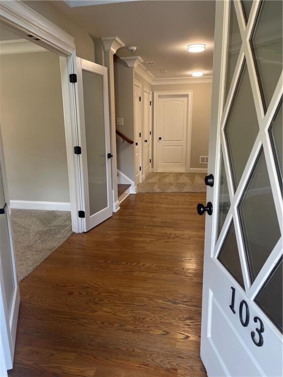 103 Mill Park Chase, Woodstock, GA 30188 - corridor with dark wood-style flooring and crown molding