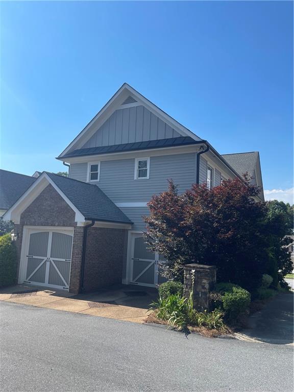 103 Mill Park Chase, Woodstock, GA 30188 - view of front of property featuring board and batten siding and brick siding