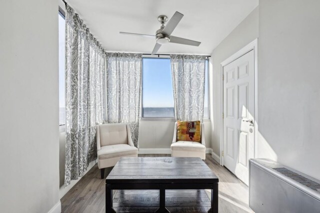 215 Piedmont Ave NE Unit 2103, Atlanta, GA 30308 - sitting room featuring baseboards, ceiling fan, and light wood-style flooring