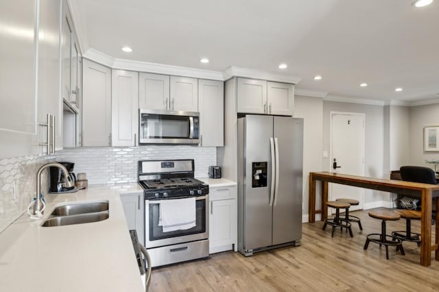 215 Piedmont Ave NE Unit 2103, Atlanta, GA 30308 - kitchen with light countertops, a sink, crown molding, and appliances with stainless steel finishes
