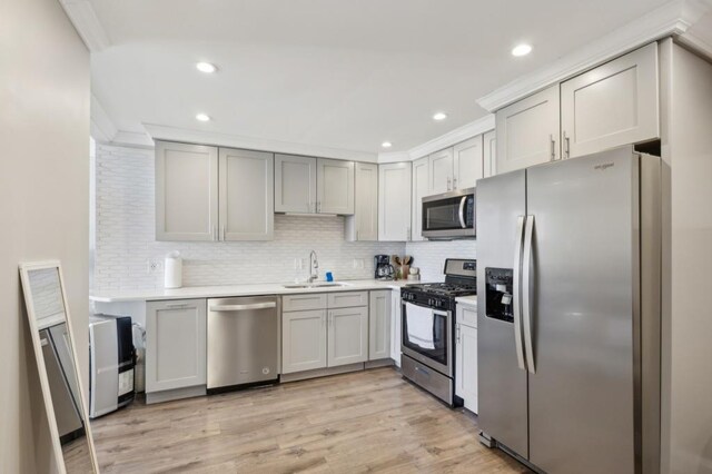 215 Piedmont Ave NE Unit 2103, Atlanta, GA 30308 - kitchen with light countertops, light wood-style flooring, a sink, and appliances with stainless steel finishes