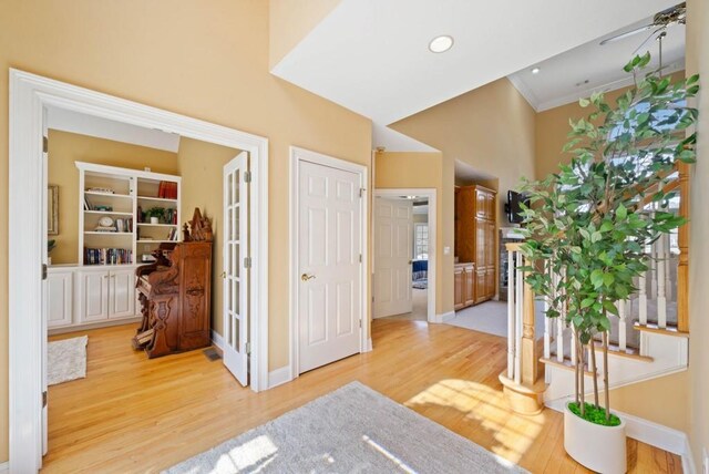 living area featuring vaulted ceiling and light hardwood / wood-style flooring