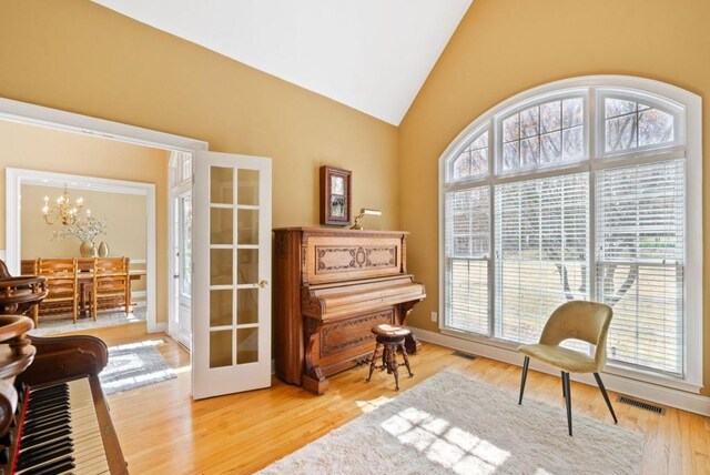 dining space with ornamental molding, plenty of natural light, a notable chandelier, and light hardwood / wood-style floors