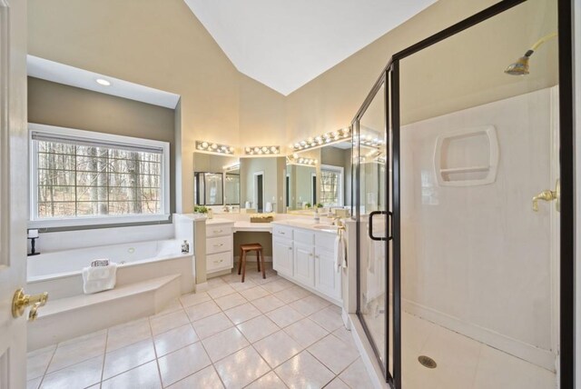 bathroom with vanity, vaulted ceiling, tile patterned floors, and shower with separate bathtub