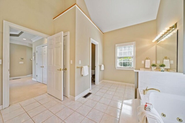 bathroom with tile patterned flooring, vanity, a bathtub, and crown molding