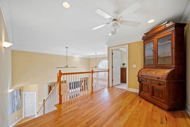 bedroom with ornamental molding, light colored carpet, and ceiling fan