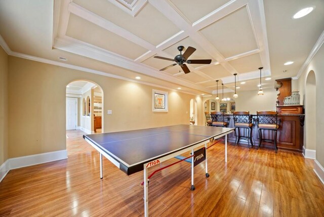 living room with coffered ceiling, crown molding, light tile patterned floors, ceiling fan, and a fireplace