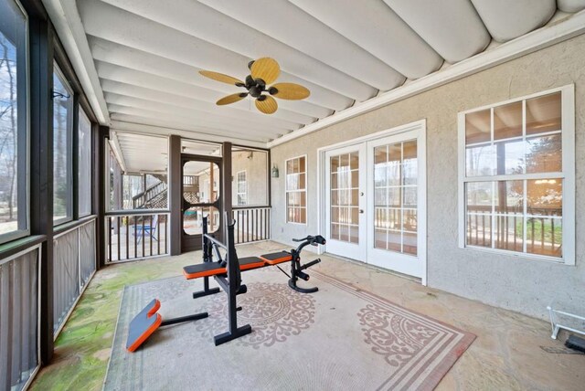 carpeted bedroom with ornamental molding, built in desk, ceiling fan, and a tray ceiling