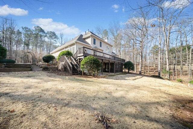 rear view of house featuring a wooden deck