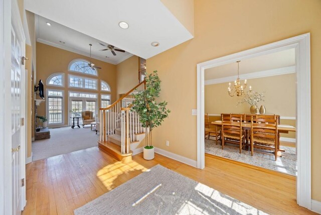 sitting room featuring french doors, high vaulted ceiling, light hardwood / wood-style flooring, and a wealth of natural light