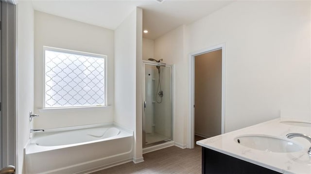 231 Malbone St SW, Cartersville, GA 30120 - full bathroom featuring a shower stall, a garden tub, double vanity, and wood finished floors