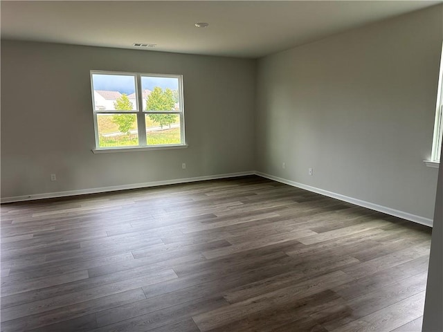 empty room featuring dark hardwood / wood-style flooring