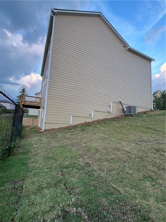 view of home's exterior with a lawn and cooling unit