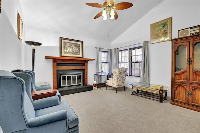 living room featuring carpet floors, ceiling fan, a fireplace, and high vaulted ceiling