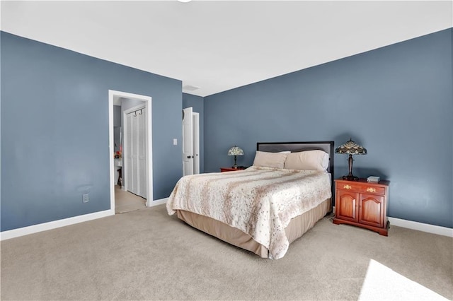 bedroom featuring light colored carpet and baseboards