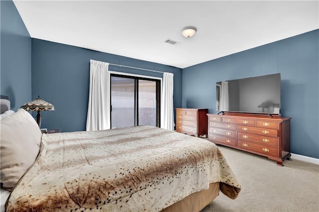 carpeted bedroom featuring baseboards and visible vents