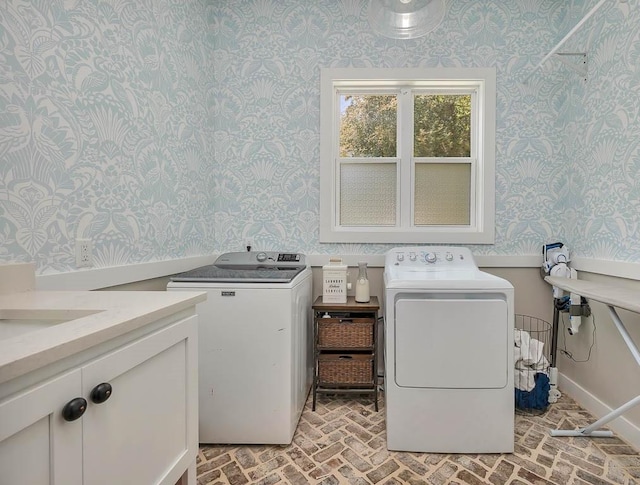 laundry room with wallpapered walls, separate washer and dryer, brick patterned flooring, and baseboards
