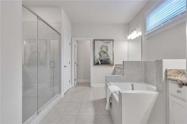 6179 Ashbranch Dr, Acworth, GA 30101 - bathroom featuring vanity, a bath, a shower stall, tile patterned flooring, and baseboards