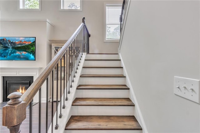 6179 Ashbranch Dr, Acworth, GA 30101 - stairs with a glass covered fireplace, healthy amount of natural light, and baseboards