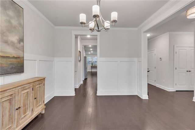 6179 Ashbranch Dr, Acworth, GA 30101 - unfurnished dining area featuring a decorative wall, a chandelier, dark wood-type flooring, ornamental molding, and a wainscoted wall