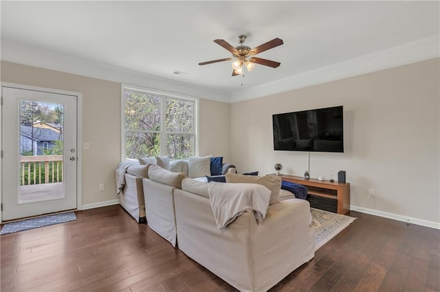 living area featuring a healthy amount of sunlight, baseboards, and dark wood finished floors