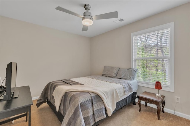 bedroom with baseboards, ceiling fan, visible vents, and light colored carpet